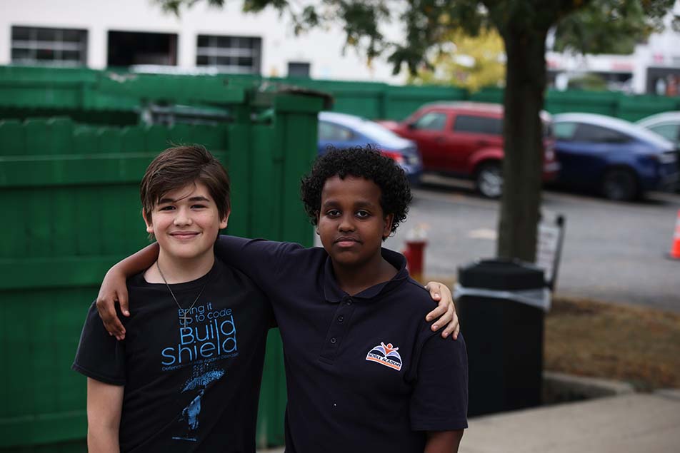 student in classroom smiling at camera