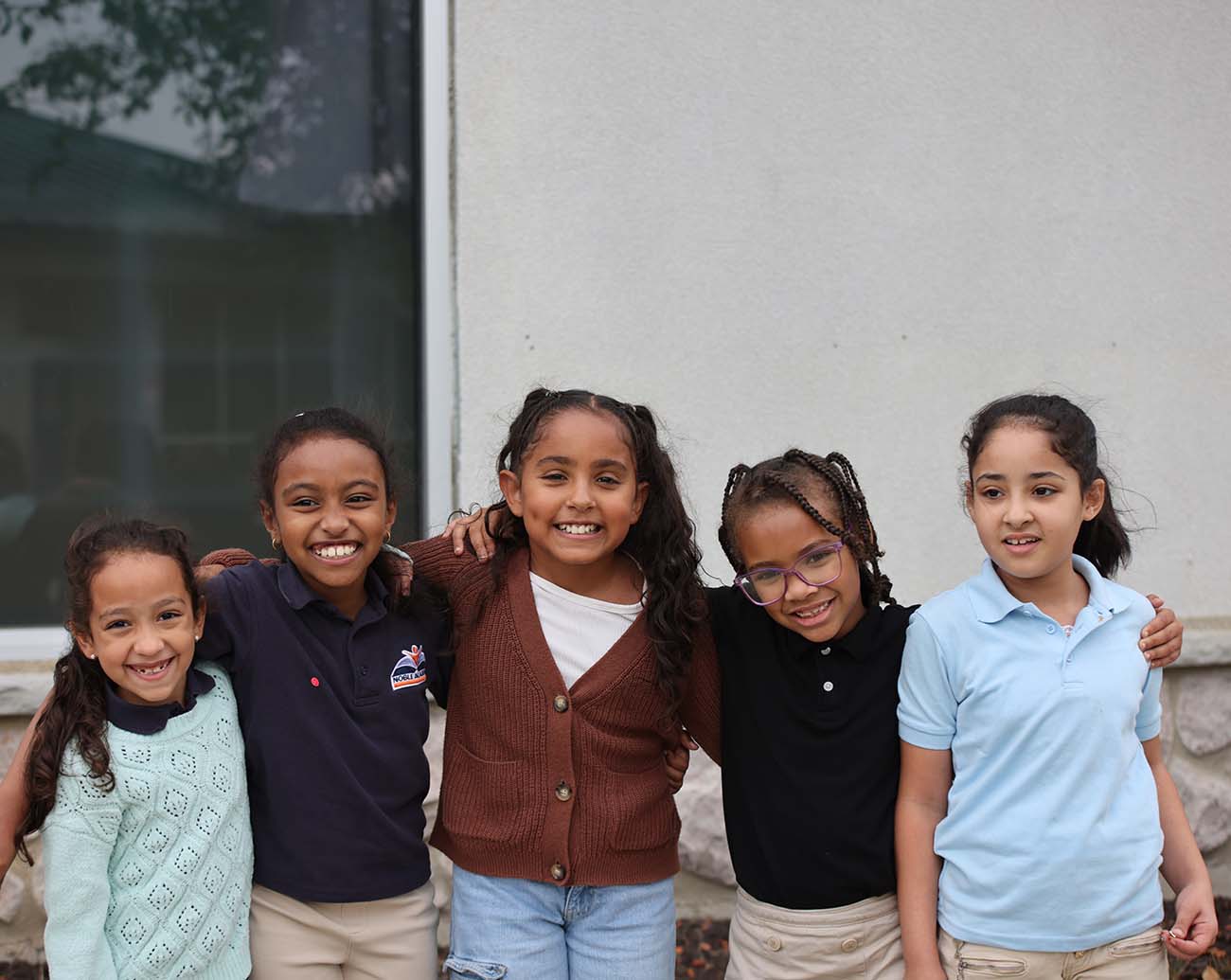 Teacher or school staff member warmly interacting with a student outside