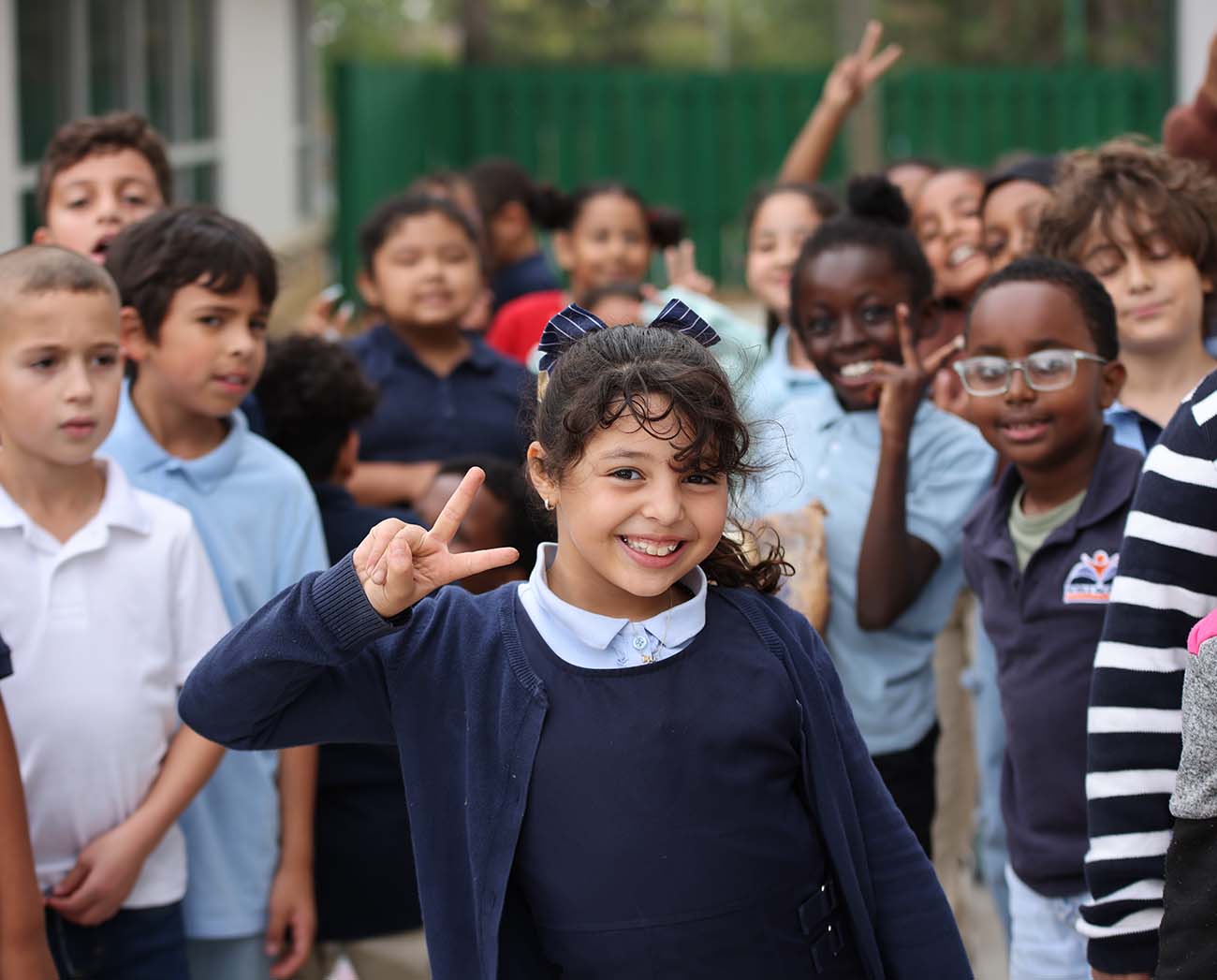 Smiling children together outdoors.